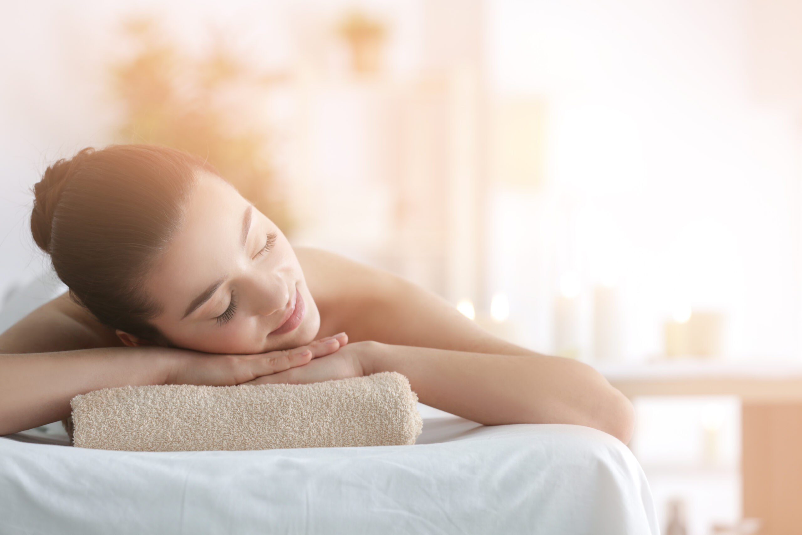 Beautiful young woman in spa salon